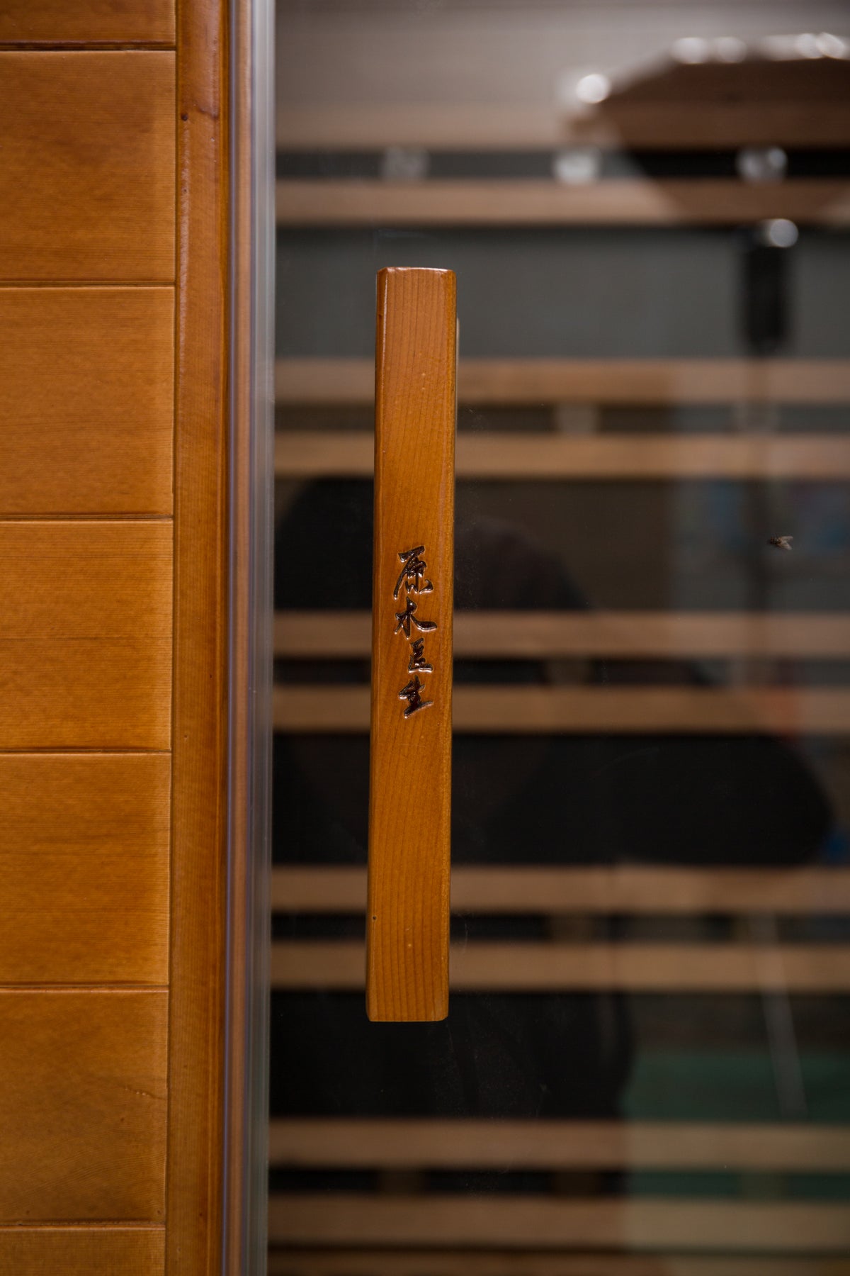 NaturalDoctor D2 two-person red cedar sauna — wooden door handle detail